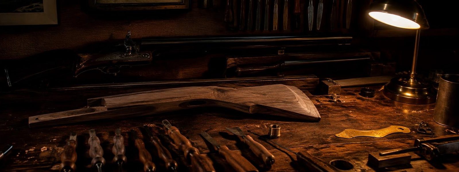 Antique gun maker workbench with chisels and a rifle stock blank